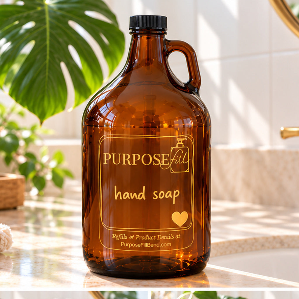 64 oz PurposeFill hand soap refill in a reusable amber glass growler with handle, black cap and gold lettering beside a bathroom sink.