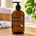 16 oz PurposeFill Premium Laundry Liquid in an amber glass bottle with black pump top in a bright laundry room in Bend, Oregon.