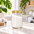 16 oz clear glass jar of PurposeFill Value Laundry Powder with gold lid in a bright laundry room, PurposeFill refill product in Bend, Oregon